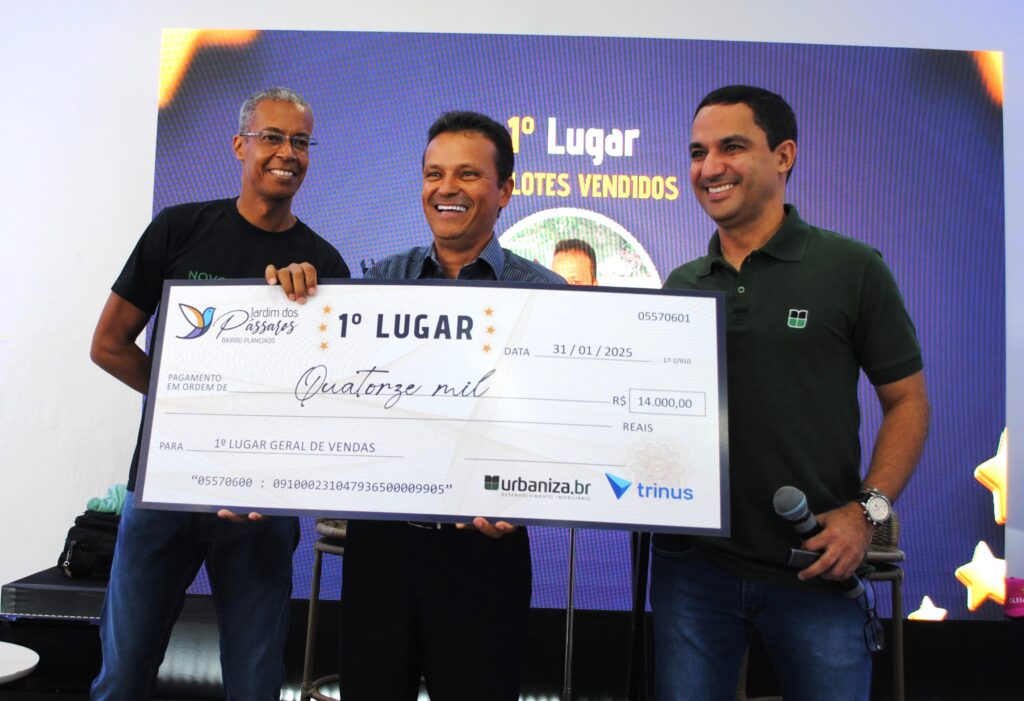 Recendo o cheque simbólico das mãos do gerente comercial Vagner Santos (à esq.) e do CEO da Urbaniza BR, Rodrigo Lima , Geraldo Garceis foi o campeão de vendas na 1ª etapa do Jardim dos Pássaros.